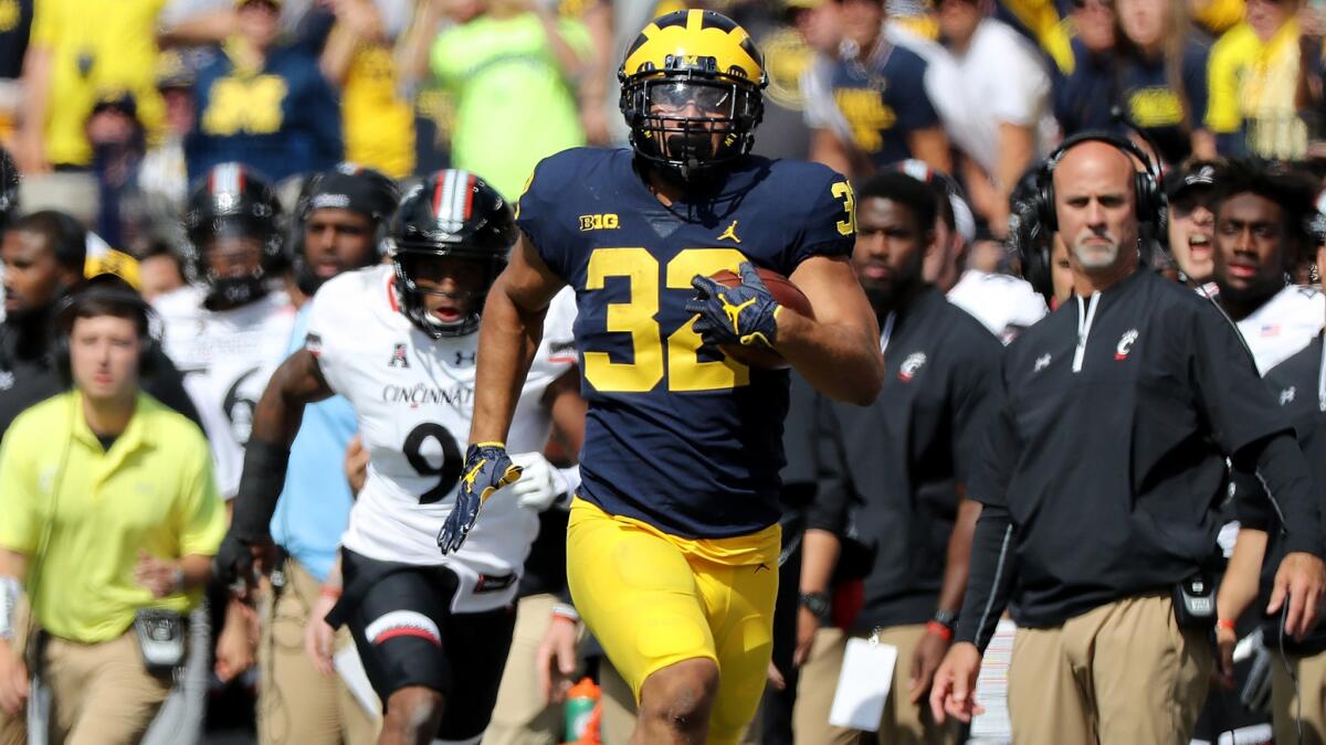 Michigan running back Ty Isaac breaks down the sideline for a long gain against Cincinnati during the fourth quarter.