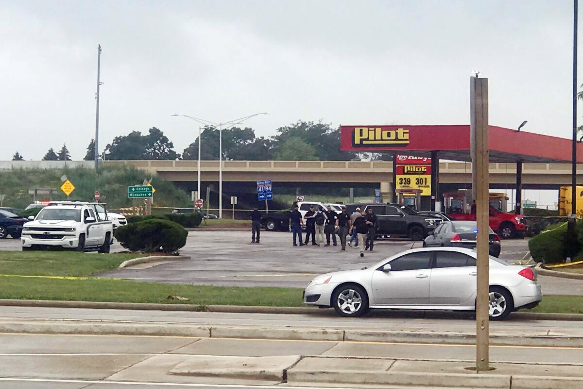 Authorities in Wisconsin respond to an apparent shooting at a Pilot Travel Center, with one witness describing a "sea of people" fleeing the store Tuesday, July 13, 2021 in Franksville, Wis. Police released few details except to say that there was no threat to the community and that they were also investigating at a second gas station about 2 miles away. (Diana Panuncial/The Journal Times via AP)