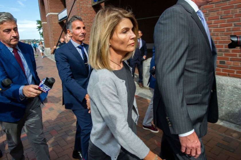 Aug. 2019 images of actress Lori Loughlin and husband Mossimo Giannulli exiting the Boston Federal Court house after a pre-trial hearing.