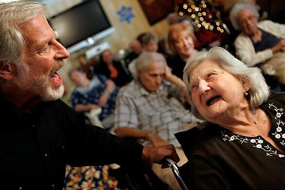 West Valley Healthcare Center resident Luisa Federovsky, 90, sings "Beautiful Dreamer" with Chris Taylor, a member of the Cabaret troupe that performs at L.A. nursing homes.