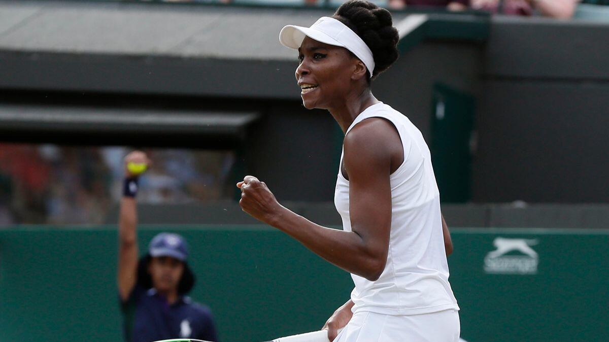 Venus Williams celebrates winning a set against Naomi Osaka during their third round women's singles match at Wimbledon on Friday.