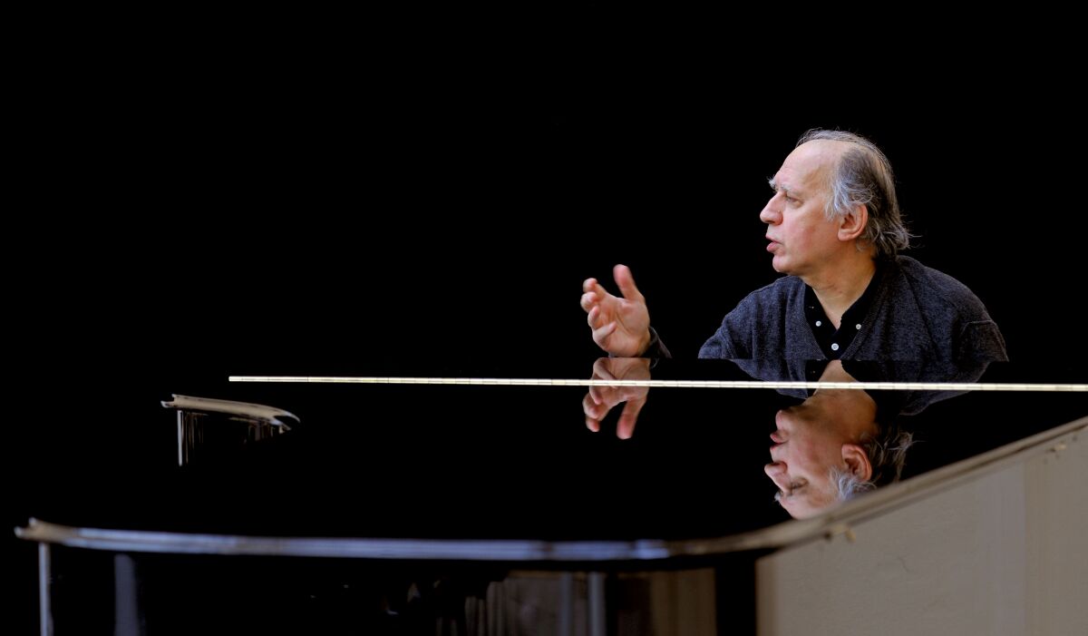A pianist performs onstage.