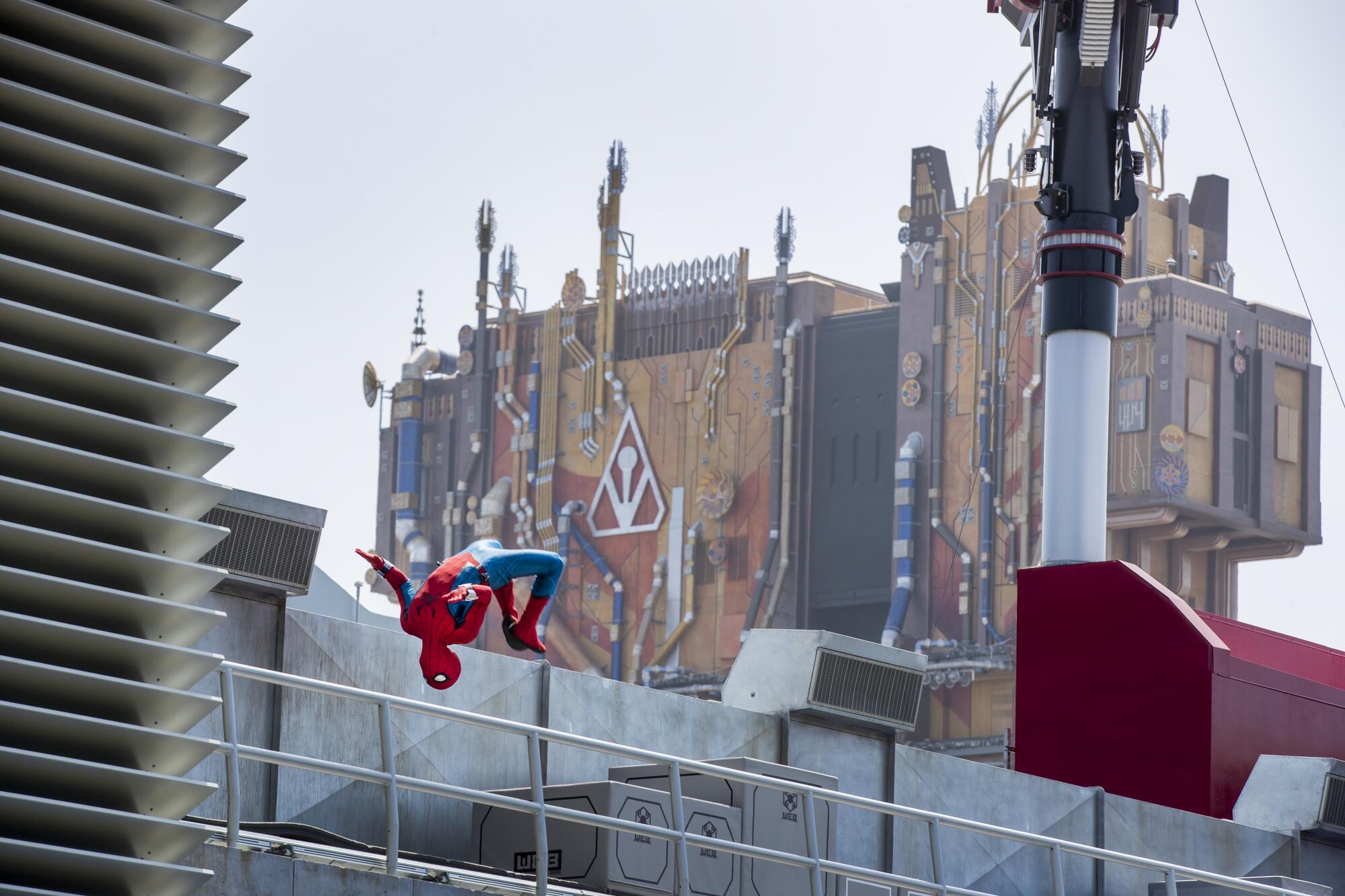 Spider-Man does a back flip while performing at Web Slingers: A Spider-Man Adventure 