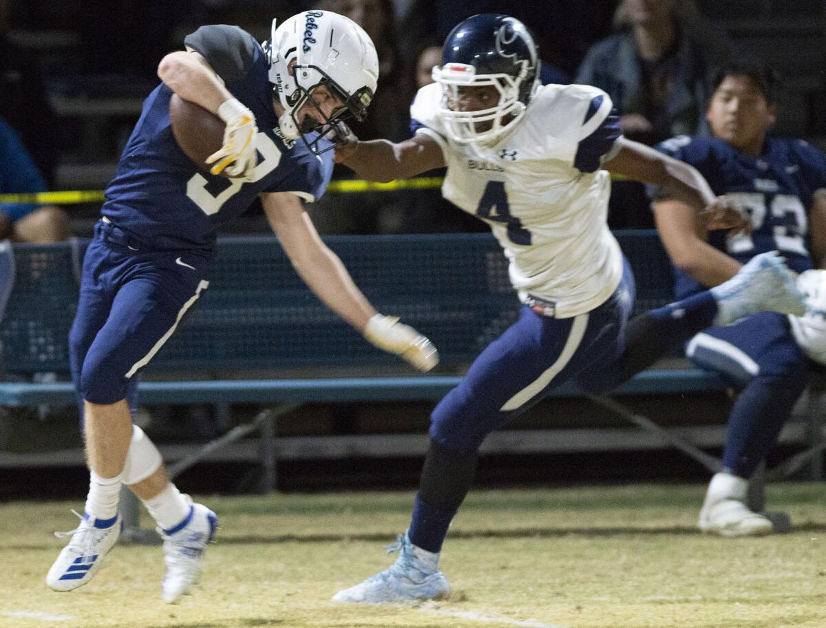 Flintridge Prep’s Kevin Ashworth is stopped by PAL Academy’s Eugene Hughes on a run during Friday's CIF Southern Section Division I playoff game at Flintridge Prep. (Photo by Miguel Vasconcellos)