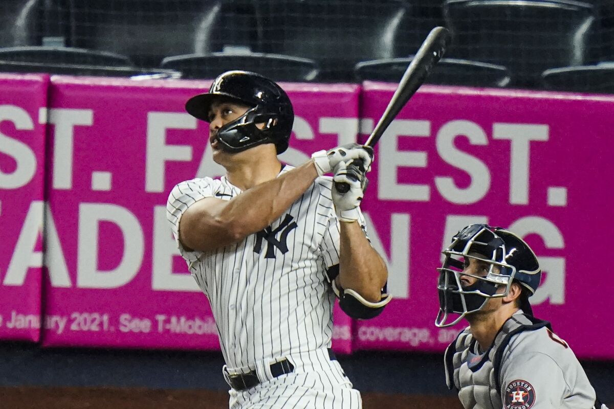 New York Yankees' Giancarlo Stanton follows through on a two-run home run during the third inning of a baseball game against the Houston Astros Wednesday, May 5, 2021, in New York. (AP Photo/Frank Franklin II)