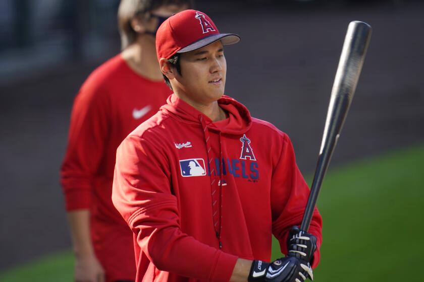 Los Angeles Angels designated hitter Shohei Ohtani warms up before a baseball game.