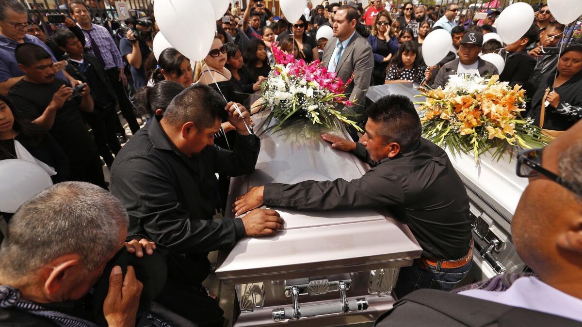 Relatives grieve at funeral services on April 2 at Our Lady of Guadalupe Church in Delano for migrant farmworkers, whose vehicle crashed as they fled immigration agents.