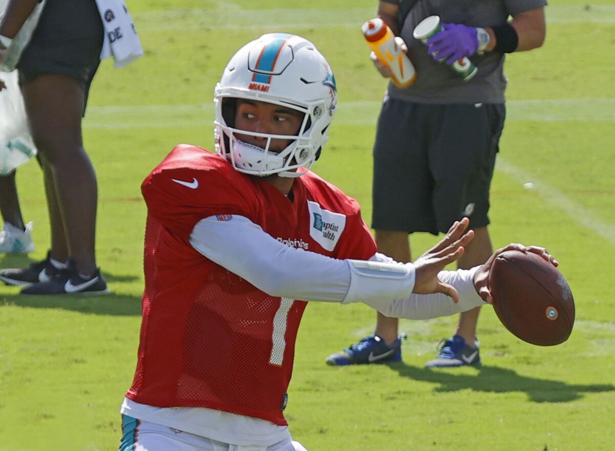 Dolphins quarterback Tua Tagovailoa sets to throw during practice.