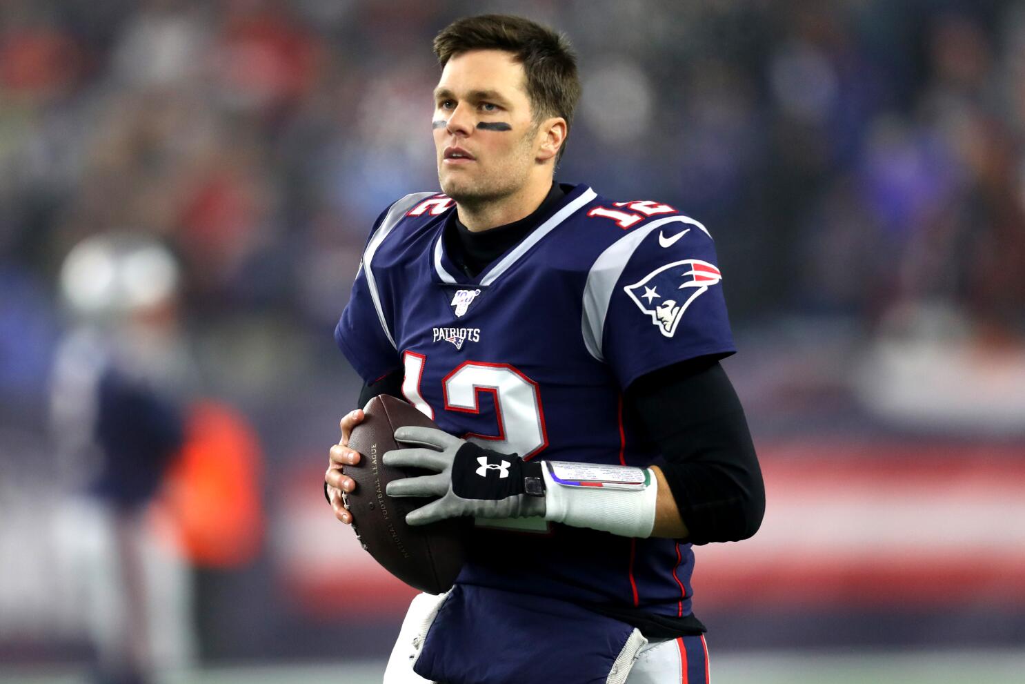 Tom Brady of the New England Patriots cheers as he runs on to the News  Photo - Getty Images