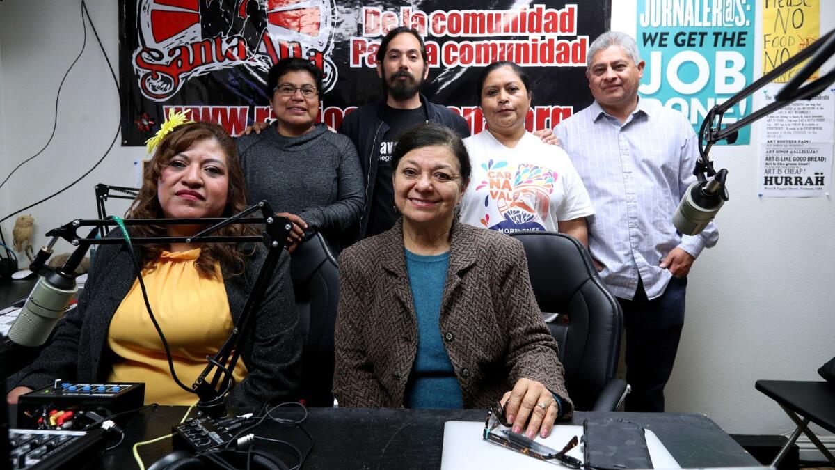 Radio Santa Ana volunteers (back row from left), Ester Hernandez, coordinator Luis Sarmiento, Dora Trejo and Rodolfo Martinez, and (front row from left), co-hosts Reyna Mendoza and Socorro Torres Sarmiento, at the station in Santa Ana.