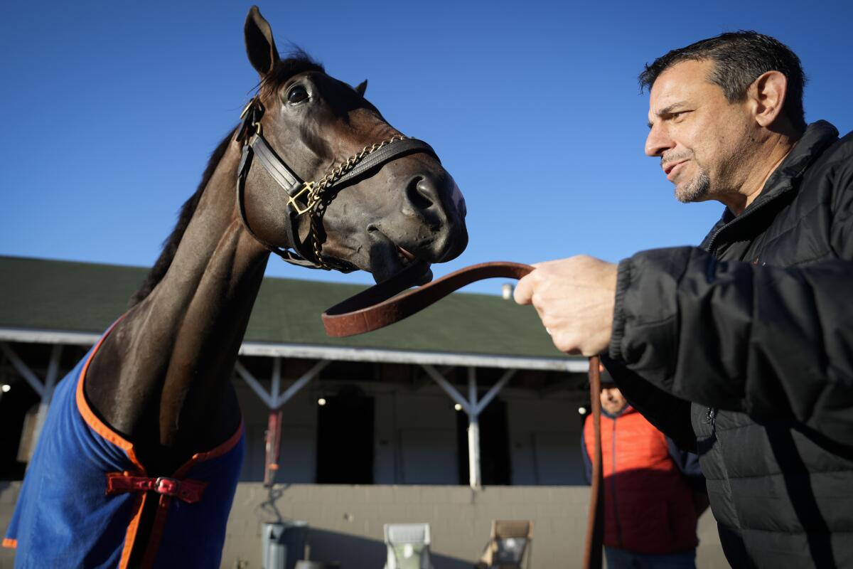 Owner Mike Repole stands with Kentucky Derby favorite Forte after a morning workout at Churchill Downs on Wednesday.