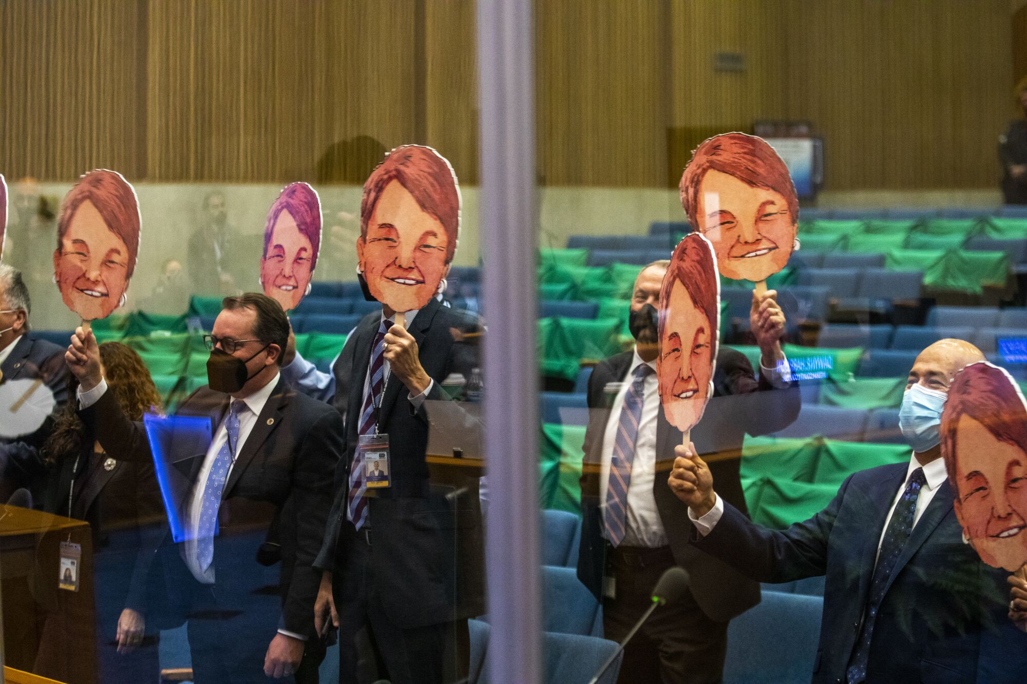 Staff hold up images of  Sheila Kuehl 