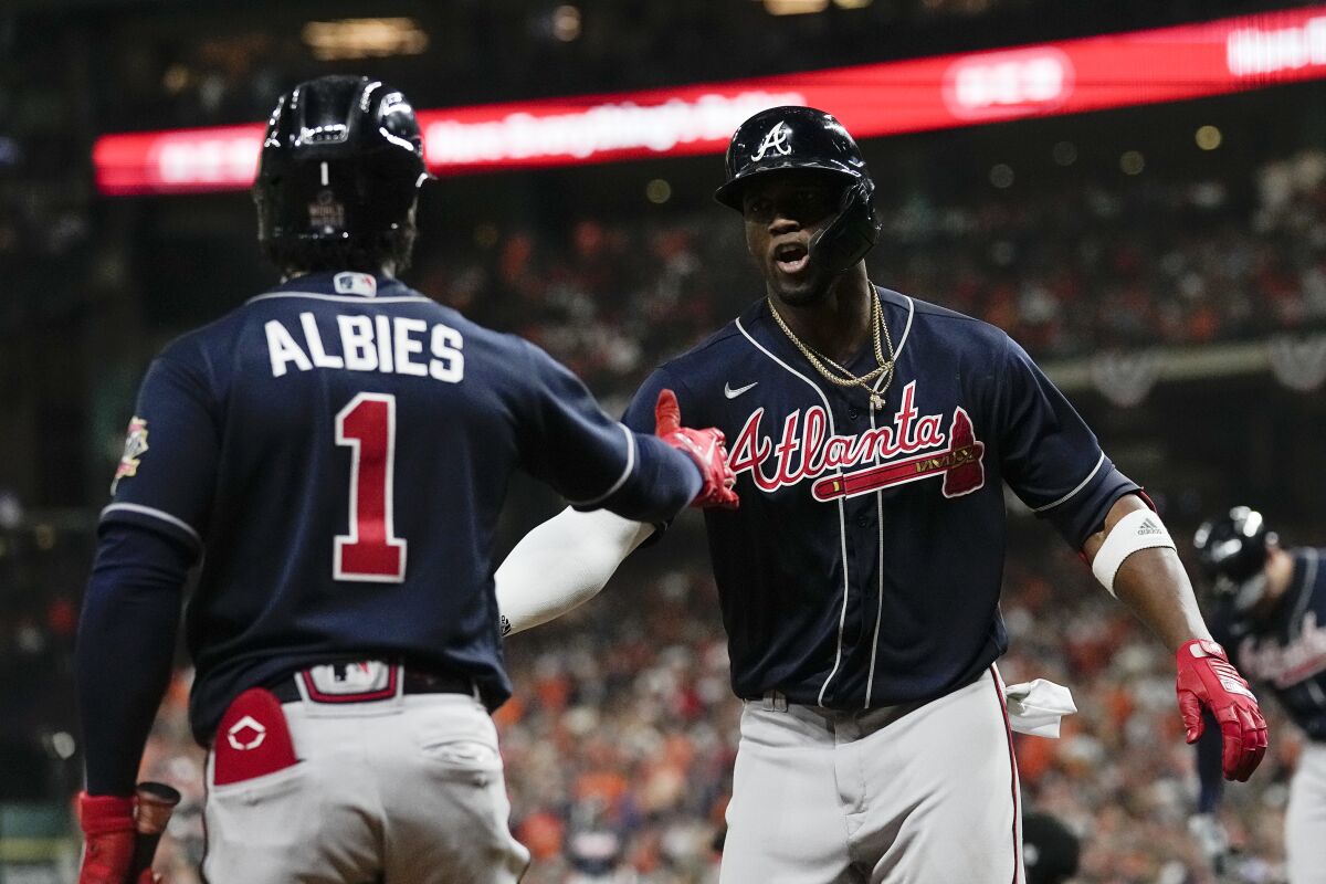 Atlanta Braves' Jorge Soler celebrates with Ozzie Albies after a home run.