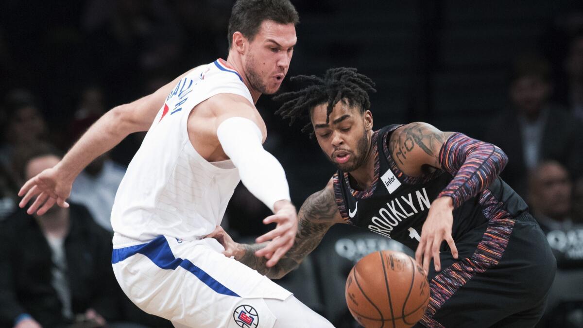 Clippers forward Danilo Gallinari strips the ball from Nets guard D'Angelo Russell (1) during the first half Saturday.