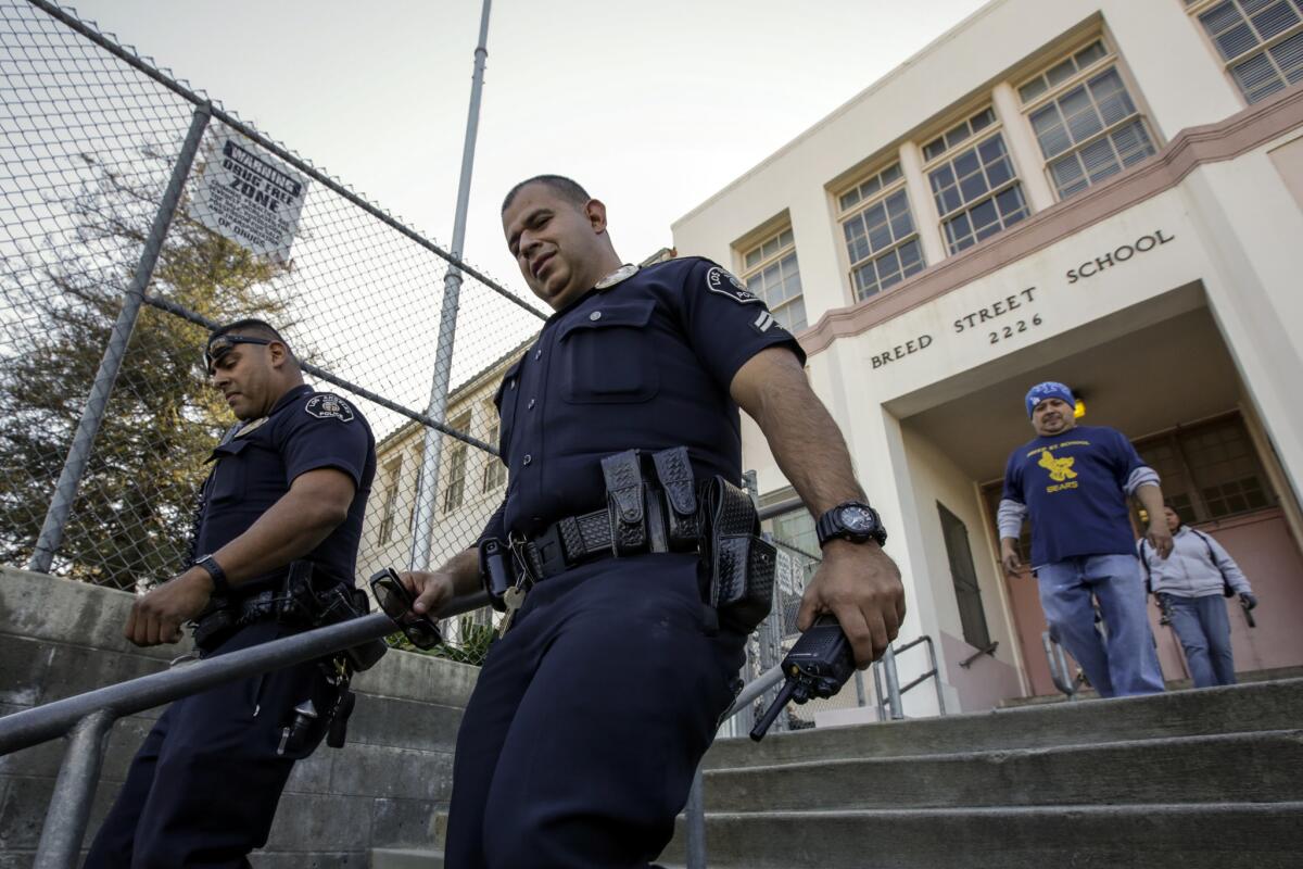 Los Angeles School Police Officers Frank Avelar, left, and Jose Zamora leave Breed Street Elementary after conducting a safety check.