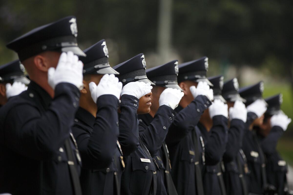 A row of police officers saluting with white gloves