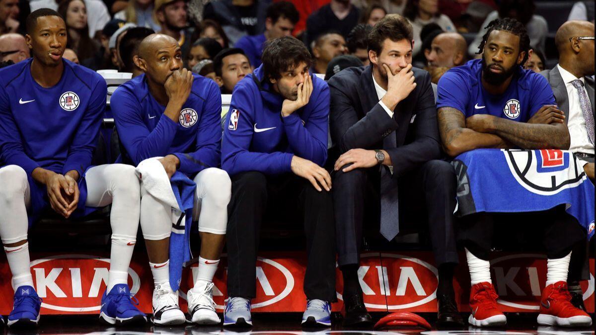 The Clippers bench can only watch as the Golden State Warriors defeat the Clippers on Saturday at the Staples Center.