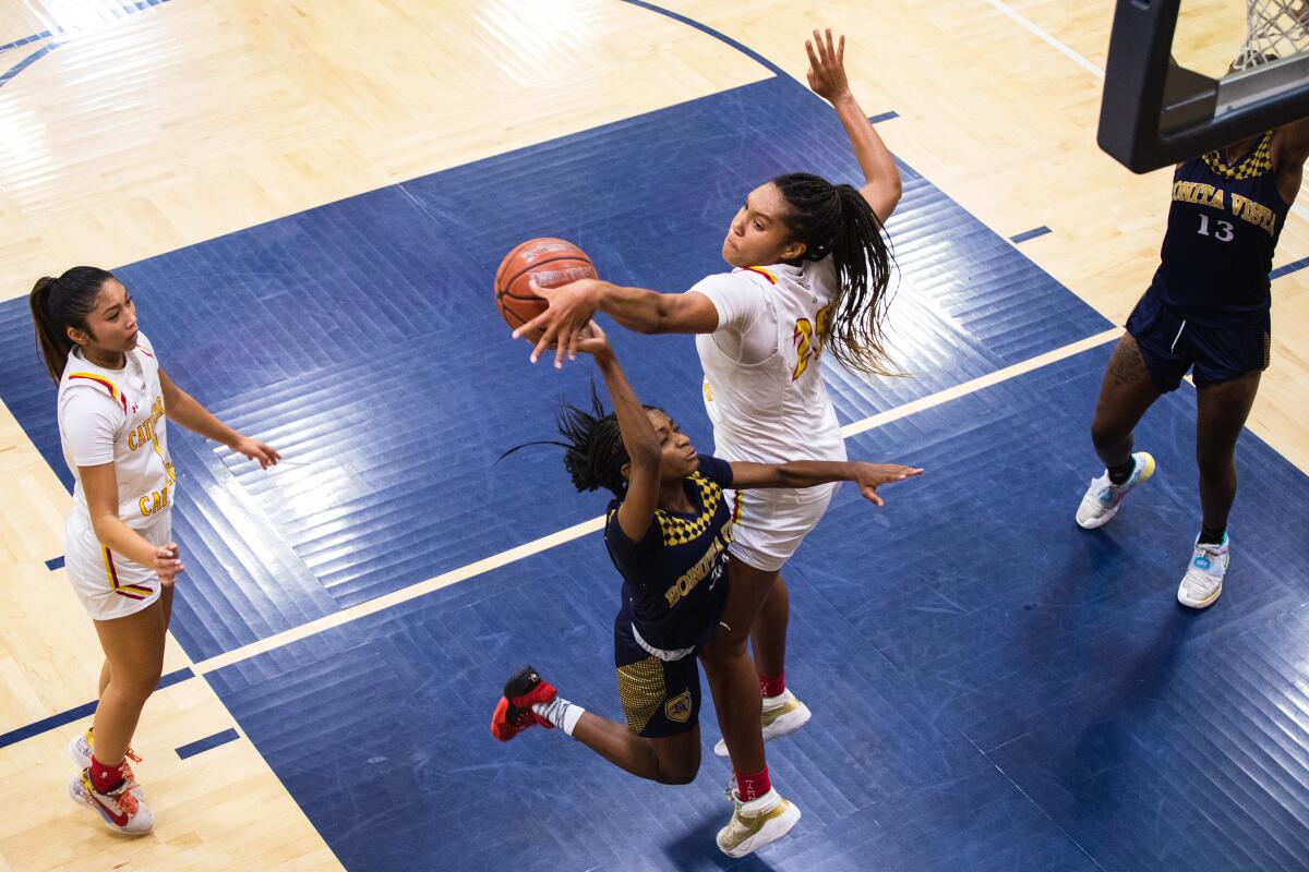 Cathedral Catholic High’s Isuneh “Ice” Brady blocks Bonita Vista High’s Kaylyn Buchanon-lamb