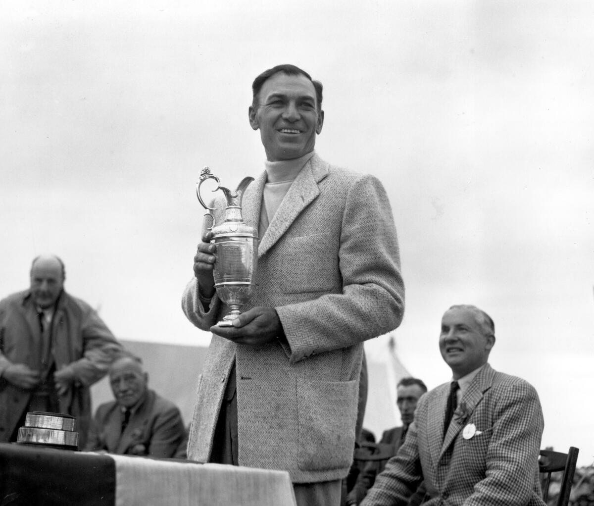 Ben Hogan holds his trophy after winning the British Open Golf Championship.