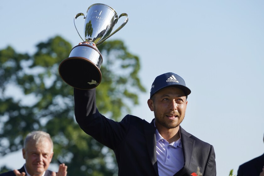 Xander Schauffele holds the trophy after winning the Travelers Championship on Sunday in Cromwell, Conn.