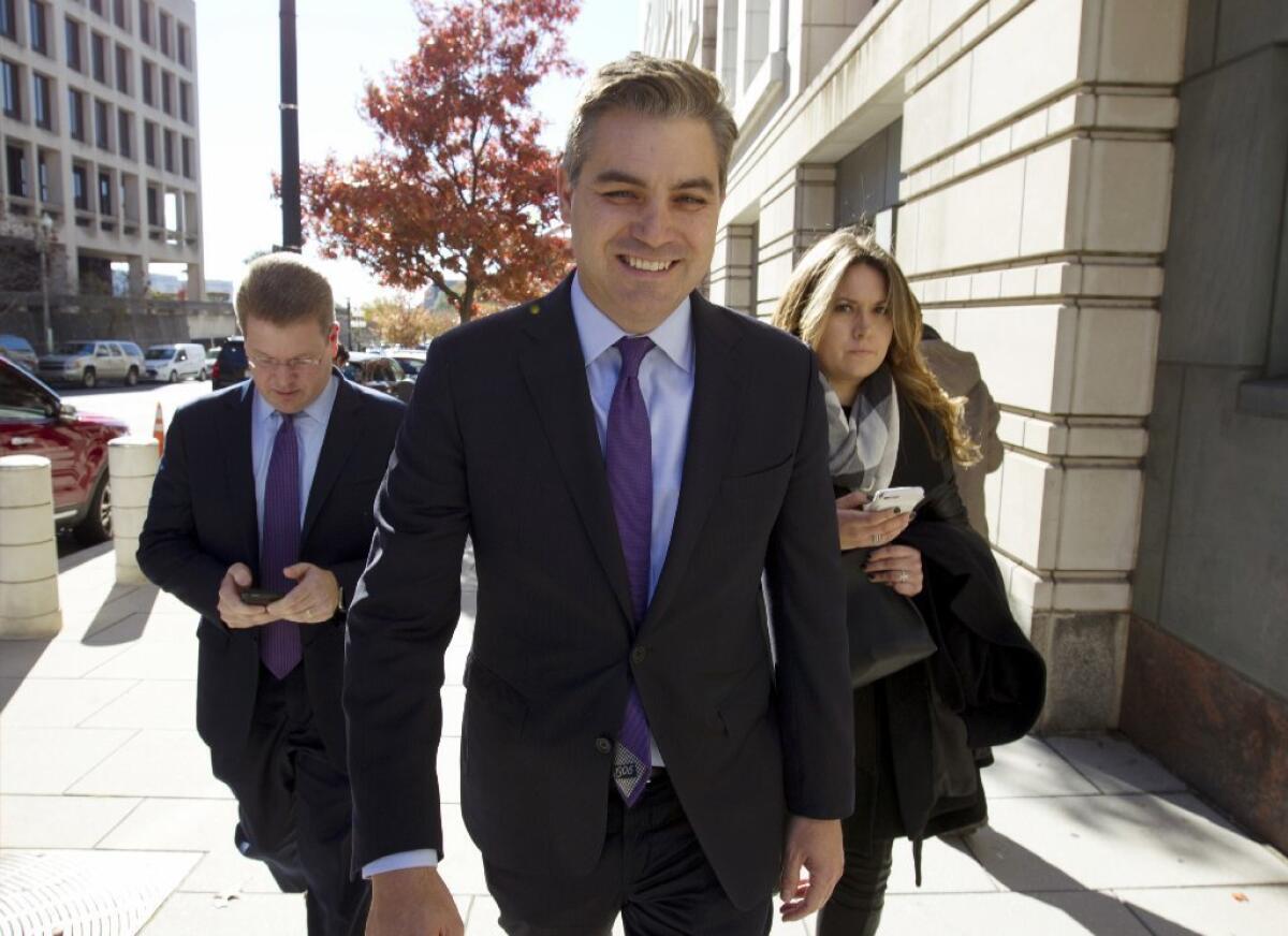Jim Acosta walks away from the U.S. District Courthouse in Washington.