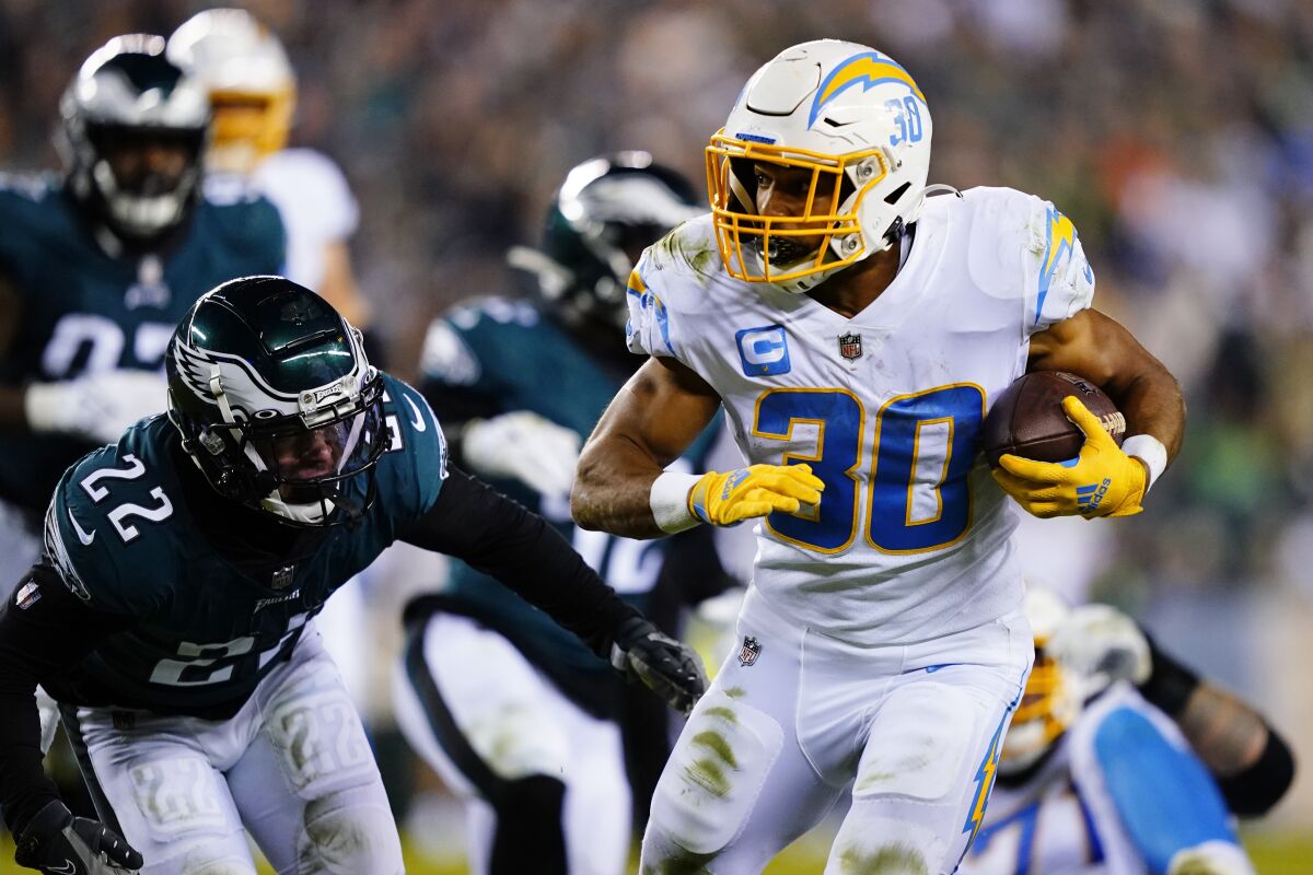 Los Angeles Chargers running back Austin Ekeler (30) runs with the ball past Philadelphia Eagles safety Marcus Epps (22) during the second half of an NFL football game Sunday, Nov. 7, 2021, in Philadelphia. (AP Photo/Matt Slocum)