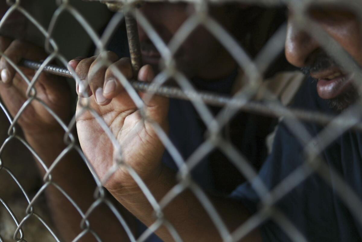 Prisoners wait to be processed for release from Abu Ghraib prison in Iraq in 2004.