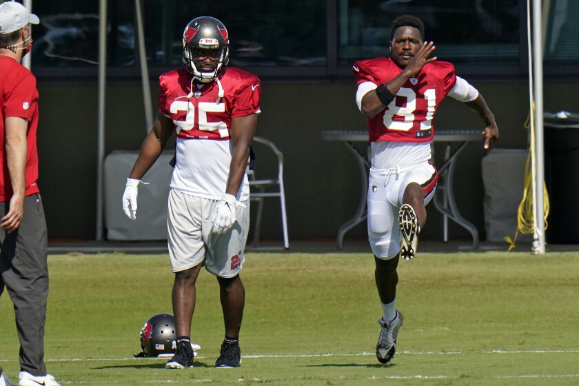 New Tampa Bay Buccaneers wide receiver Antonio Brown (81) runs along side running back LeSean McCoy (25) during an NFL football practice Thursday, Nov. 5, 2020, in Tampa, Fla. (AP Photo/Chris O'Meara)