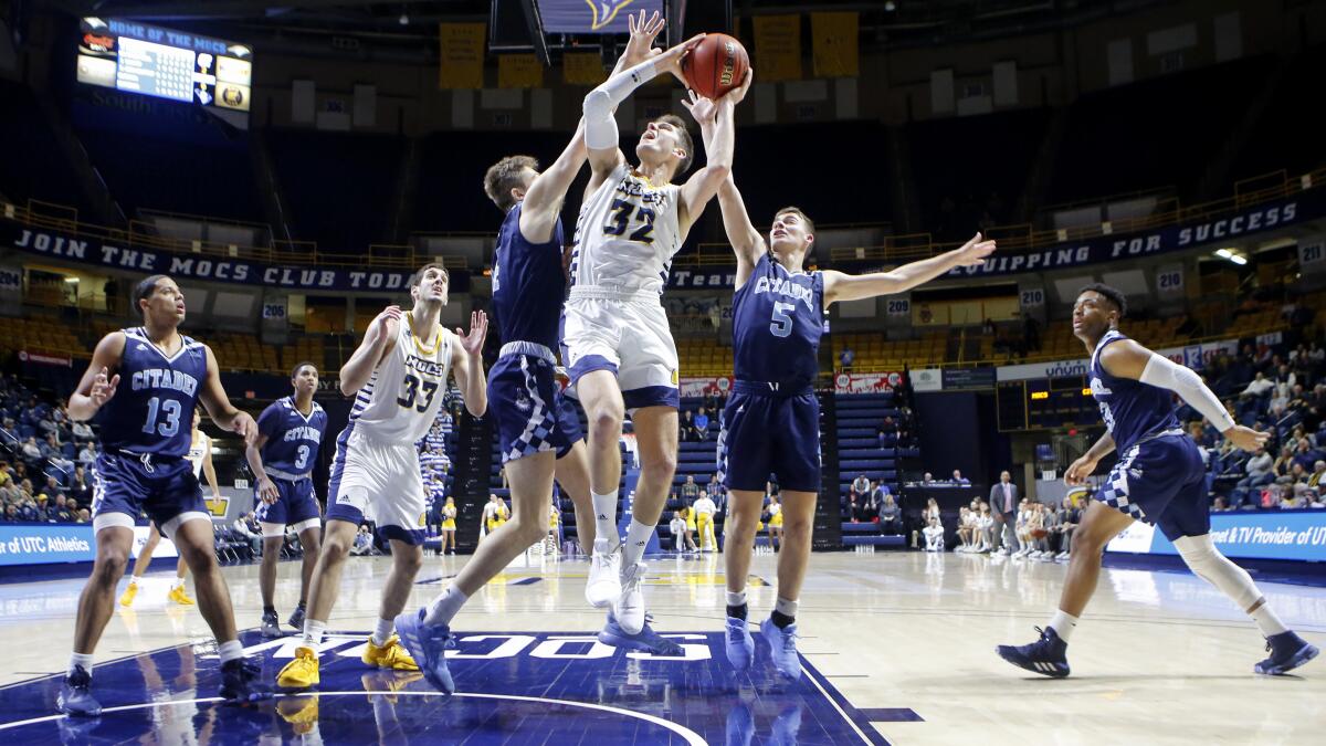 Chattanooga forward Matt Ryan is fouled attempting a short-range shot during an NCAA game against The Citadel in 2020.