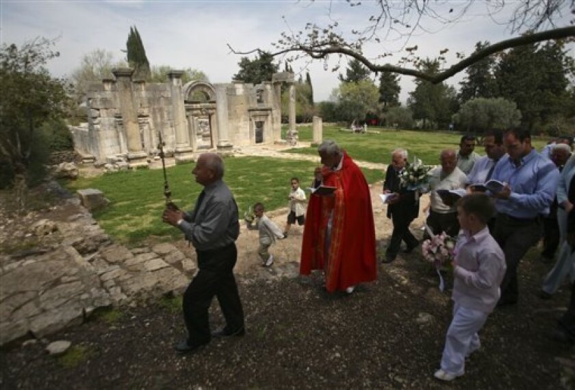 Former residents of the destroyed Israeli village of Biram and their families celebrate Easter in the ruins of the village, Sunday, April 5, 2009. Displaced during war decades ago, Christians of the destroyed village of Biram say they still long to resettle here. (AP Photo/Dan Balilty)
