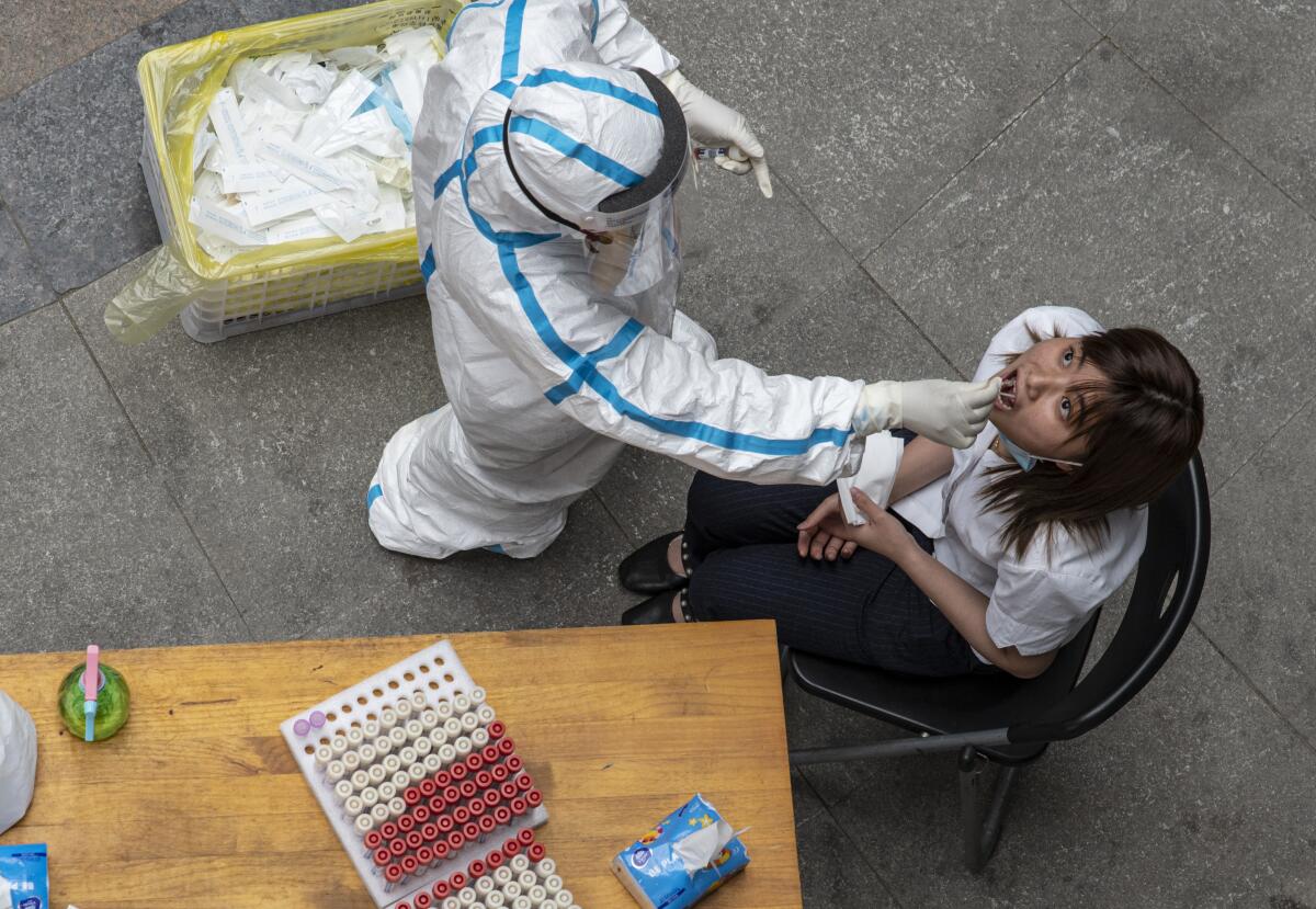 A Wuhan resident is tested for the coronavirus. The new infections reported May 10, 2020, were the first since early April.