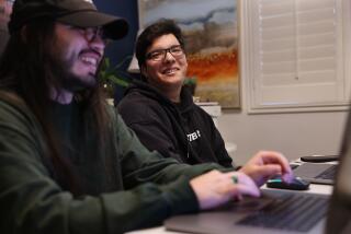 GARDENA-CA-MARCH 22, 2024: D'Angelo Ahumada, 18, center, sits with his mentor Matthew Pena, left, at home in Gardena on March 22, 2024. Disability rights groups and advocates have praised the Self-Determination Program, but complain that getting in can be demanding and take time - barriers that have led to underrepresentation of Latinos like Ahumada. (Christina House / Los Angeles Times)