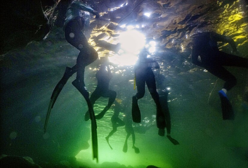 Snorkelers check out the scenery as they swim through the La Jolla Cave on Monday, August, 8, 2022 in La Jolla, CA.
