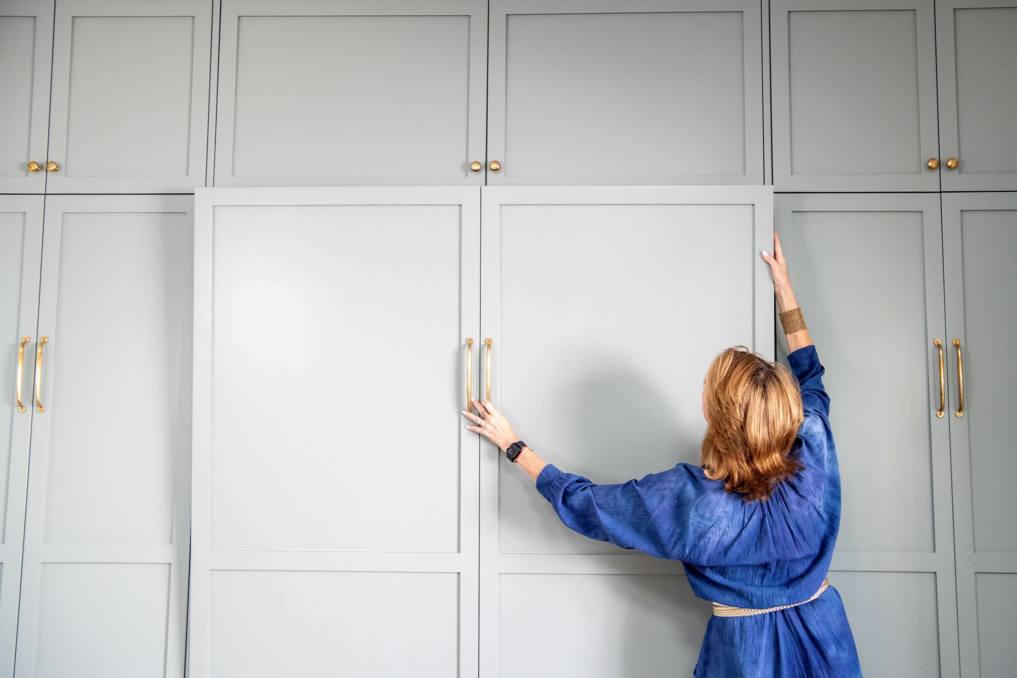 Nicole Fitzgerald demonstrates putting away the Murphy bed 