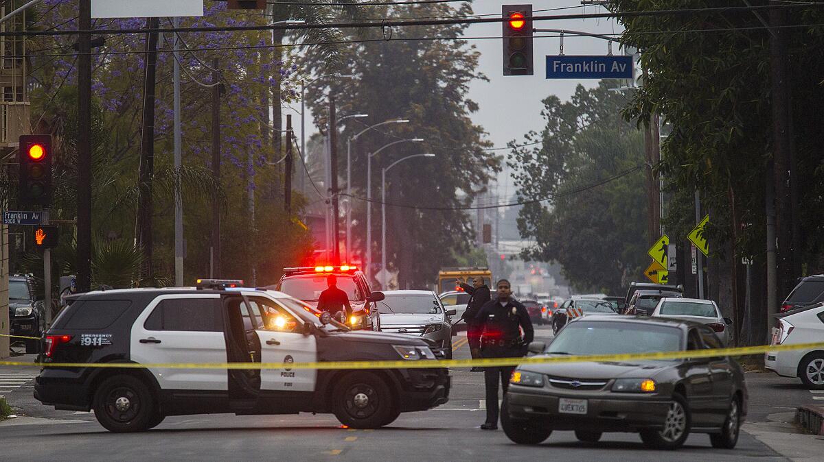 LAPD officers investigate the scene of a police shooting near Franklin Avenue in Hollywood.