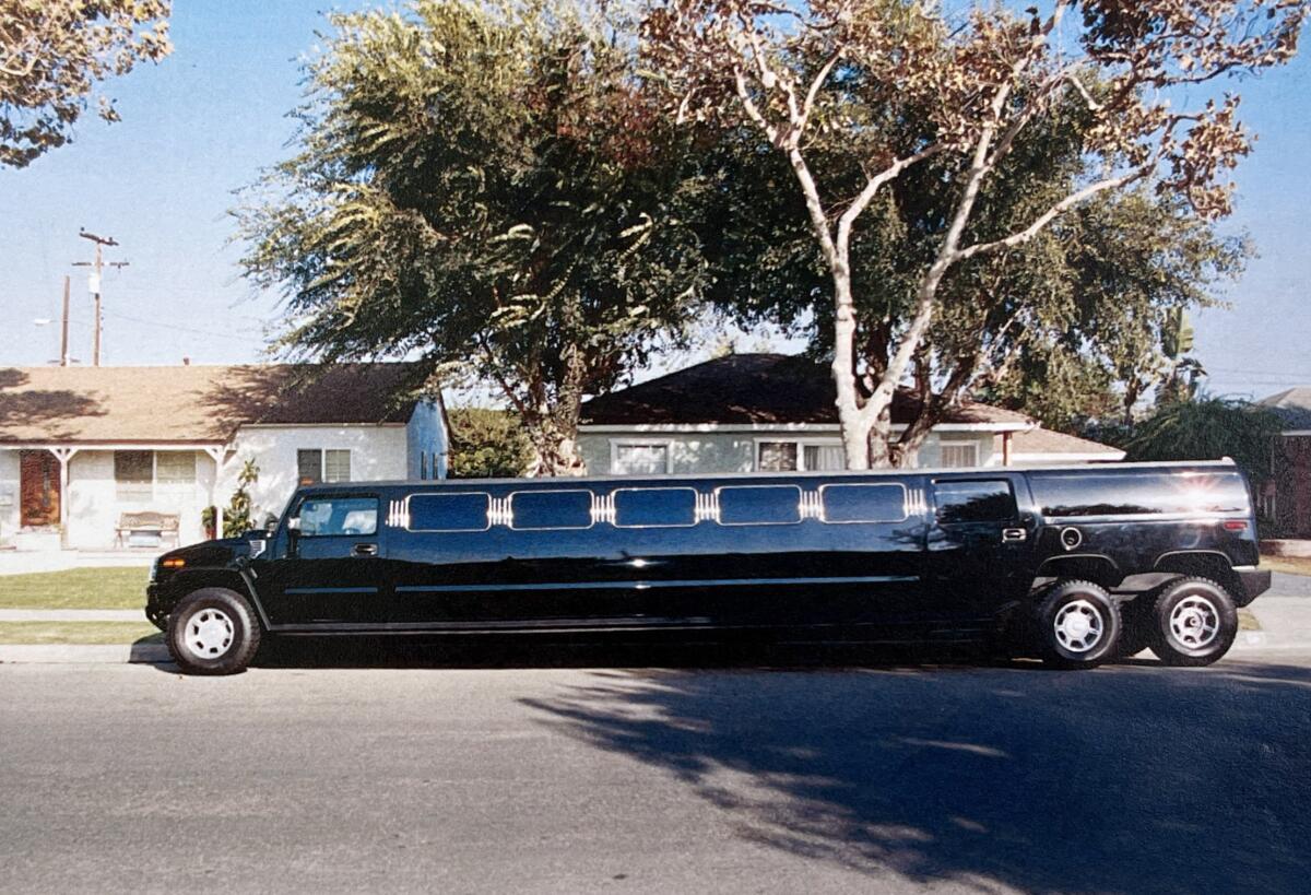 A very long limousine on a residential street