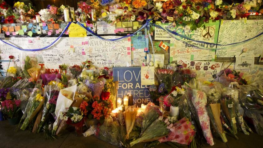 Flowers, cards and words of sympathy adorn a makeshift memorial for victims of the mass killing on April 24 in Toronto. Alek Minassian, 25, is in custody after the driver of a white rental van sped onto a crowded sidewalk, killing 10 and injuring at least 16.