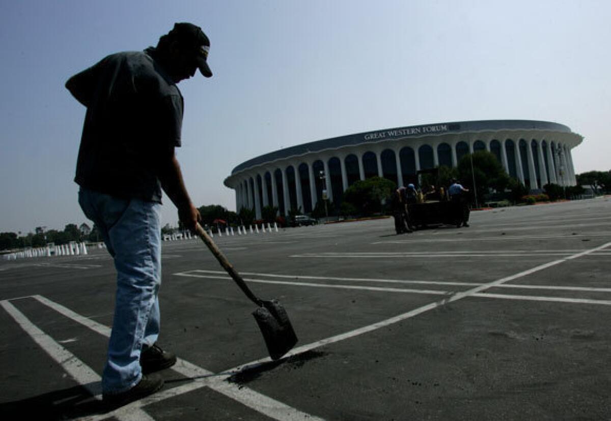 MSG, the new owner of the Forum, has paid $23.5 million for the facility and will start work this year on a $50-million renovation. The makeover is intended to turn the Forum into a top-flight concert hall and will take at least a year. Above, a worker fills potholes in the Forum's parking lot in 2005.