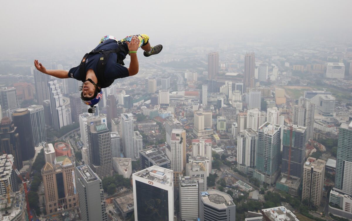 Base jumper Vince Reffet leaps from the 984-foot open deck of Malaysia's Kuala Lumpur Tower.