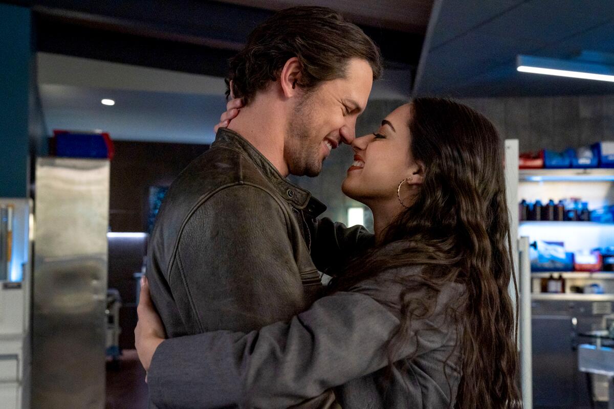 Nathan Dean and Jeanine Mason embrace in a scene from the CW's "Roswell, New Mexico"