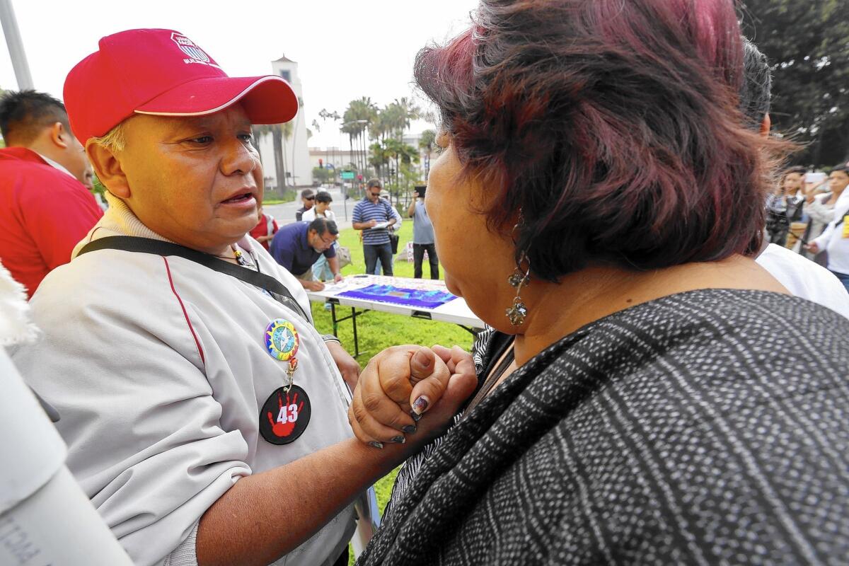 Estanislao Mendoza Chocalate, left, father of missing student Miguel Angel Mendoza Zacarias, speaks with Juana Nicolas. A march from Plaza Olvera to the Mexican consulate will take place Sunday.