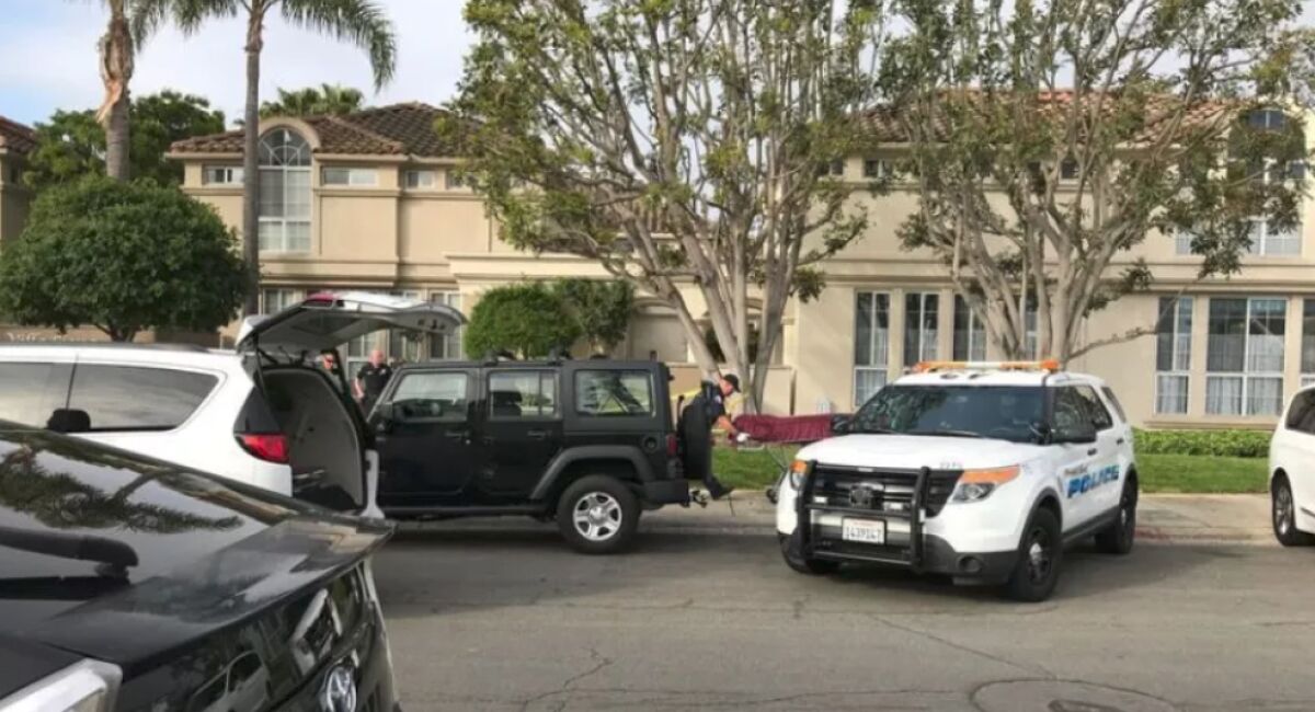 A police vehicle outside a condo where a man and woman were found dead.