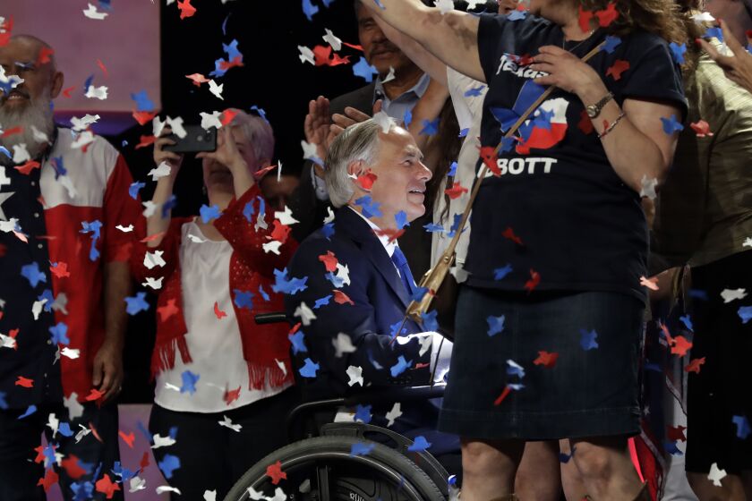 File - In this June 15, 2018 file photo, Confetti falls as Texas Gov. Greg Abbott, center, greets supporters after speaking at the Texas GOP Convention, in San Antonio. The Texas Supreme Court has upheld Houston's refusal to allow the state Republican convention to hold in-person events in the city due to the coronavirus pandemic. The court on Monday, July 13, 2020, dismissed an appeal of a state district judge's denial of a temporary restraining order sought by the state Republican Party. The state GOP convention was scheduled to begin Thursday at Houston's downtown convention center. (AP Photo/Eric Gay File)