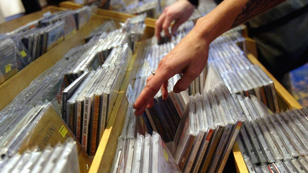 Customers browse through CD bins at a music store in New York in 2004.