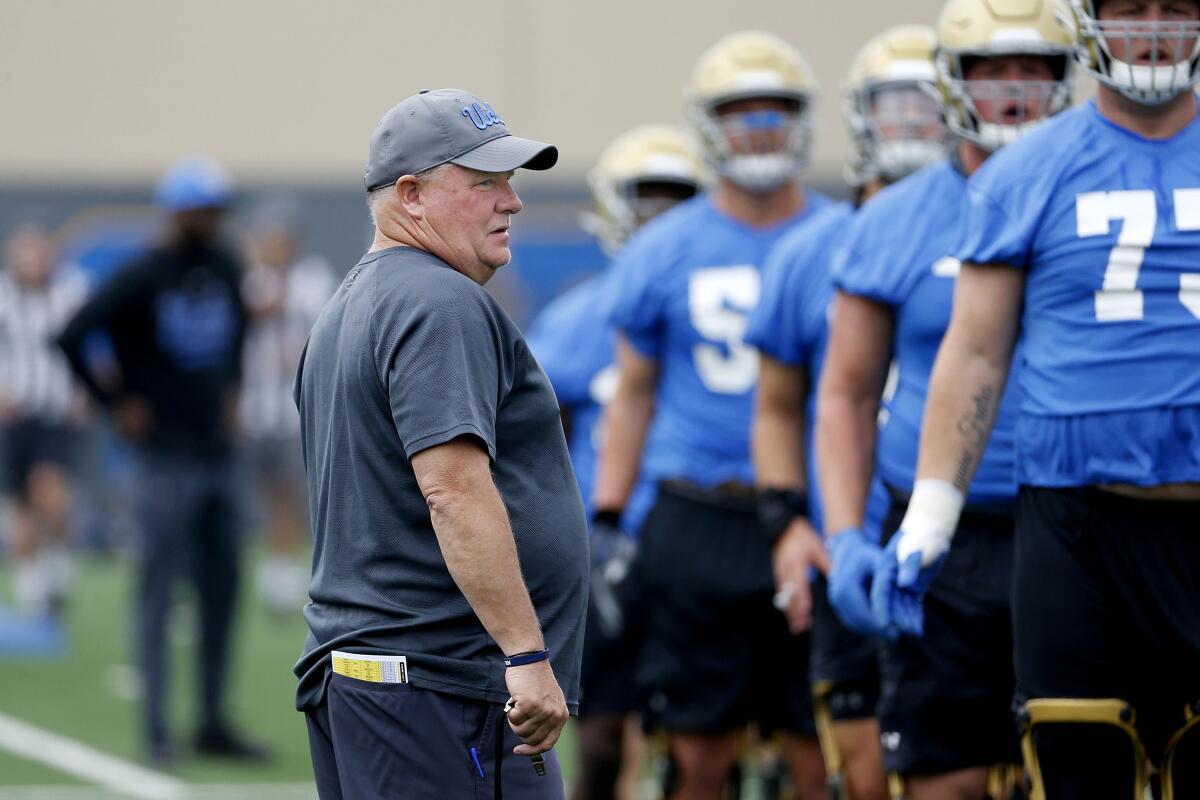 UCLA coach Chip Kelly talks to players during practice at the Wasserman Football Center on July 31, 2019. 
