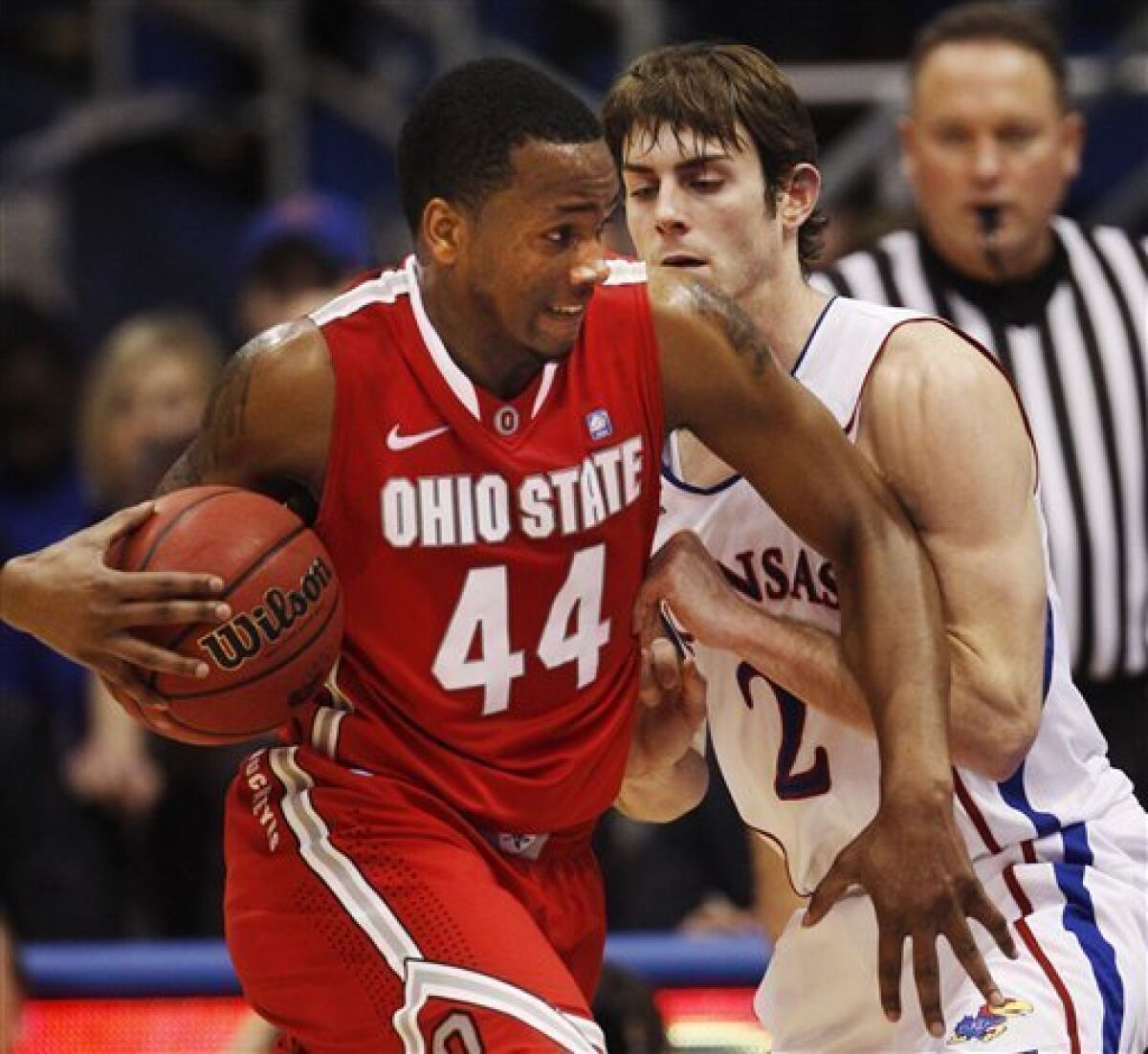 Ohio State guard William Buford (44) is covered by Kansas guard Conner Teahan (2) during the first half of an NCAA college basketball game in Lawrence, Kan., Saturday, Dec. 10, 2011. (AP Photo/Orlin Wagner)
