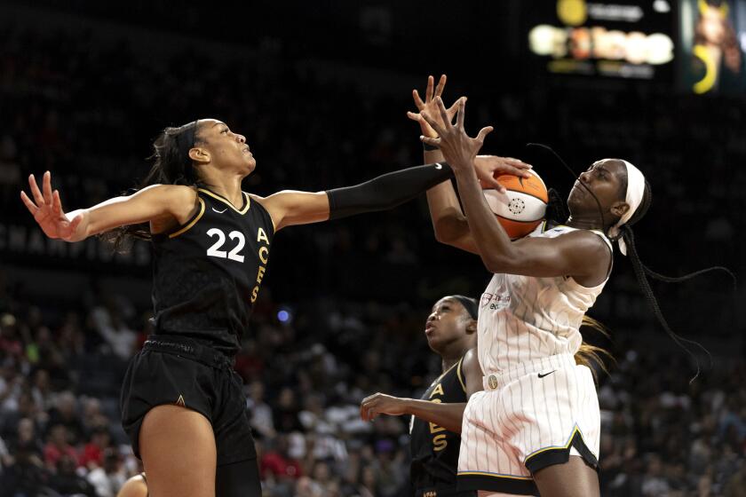 Las Vegas Aces forward A'ja Wilson (22) swats down a shot by Chicago Sky center Elizabeth Williams, right, during the first half of Game 2 of a WNBA basketball playoff series game, Sunday, Sept. 17, 2023, in Las Vegas. (Ellen Schmidt/Las Vegas Review-Journal via AP)