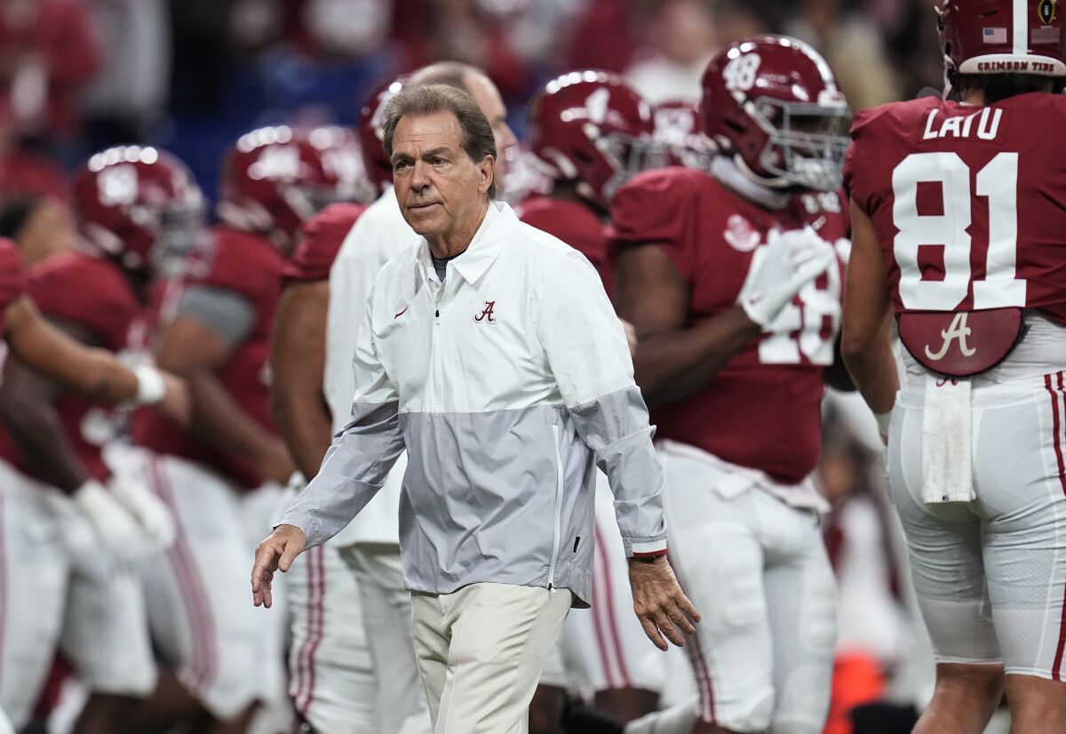 FILE - Alabama coach Nick Saban watches players warm up for the College Football Playoff championship NCAA football game against Georgia on Jan. 10, 2022, in Indianapolis. Saban is concerned about the current state of college football. He recently told The Associated Press "I don't think what we’re doing right now is a sustainable model.” (AP Photo/Paul Sancya, File)