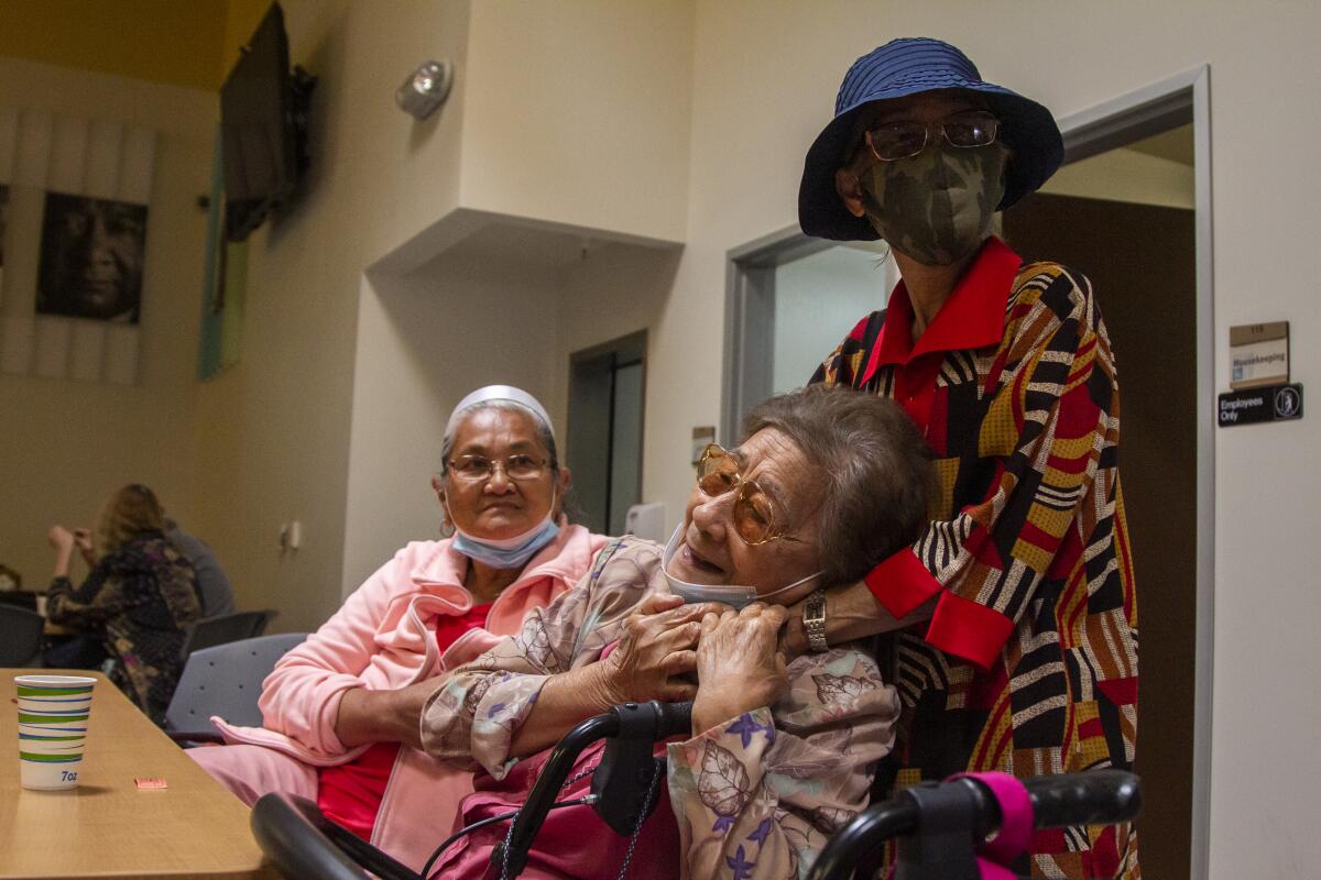 Carmencita Hyles watches her friend Primitiva Antonio reunite with Elena Batesting at the Gary and Mary West center