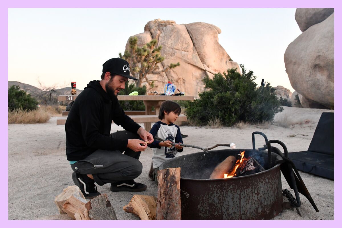 Cory McPherson and son Benjamin of Long Beach roast a marshmallow in the Hidden Valley Campground, Joshua Tree National Park.
